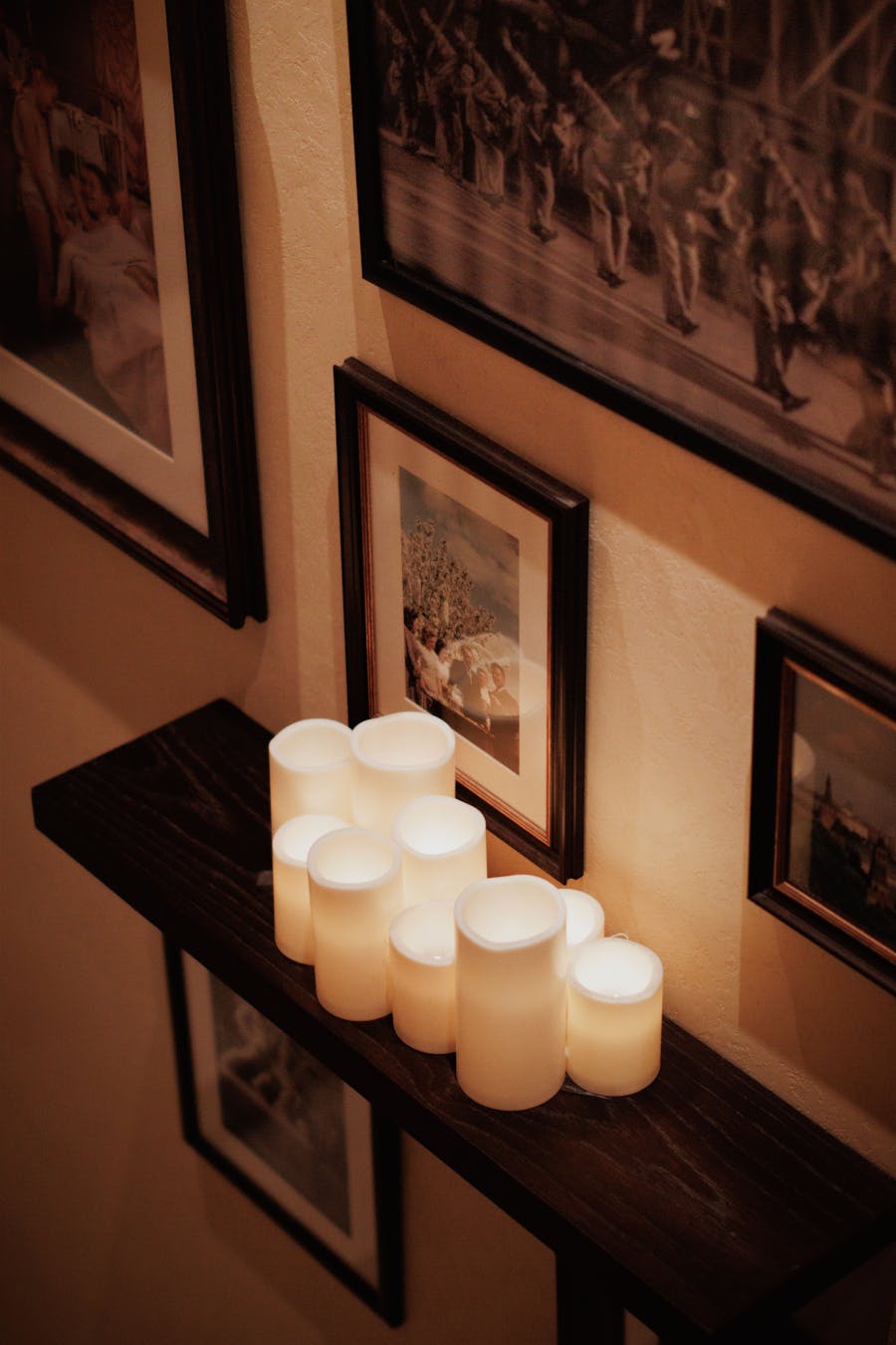 Warm candles arranged on a shelf as lifestyle inspiration