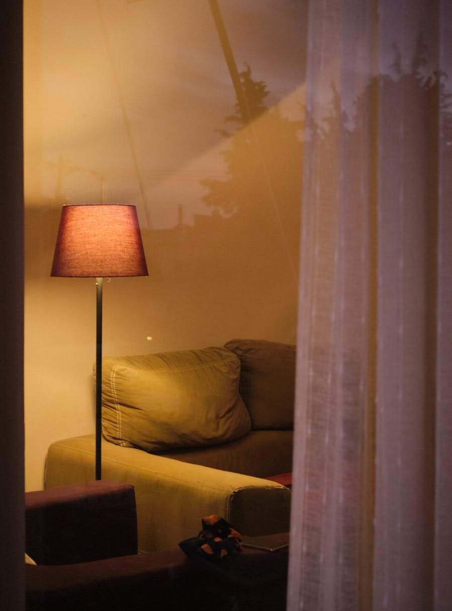 Warm floor lamp beside a sofa as lifestyle inspiration